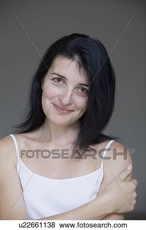 Portrait of mid-adult woman, close-up view, studio shot View Large Photo Image Stock Photo - Portrait of mid-adult woman, close-up view, studio shot. Fotosearch