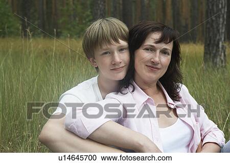 Portrait of mother and son in meadow View Large Photo Image Stock Image - Portrait of mother and son in meadow. Fotosearch