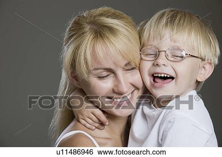 Portrait Of Mother And Son Laughing, Studio Shot View Large Photo Image Stock Photograph - Portrait Of Mother And Son Laughing, Studio Shot. Fotosearch