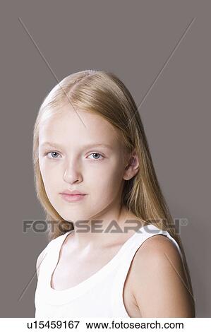 Stock Photo - Portrait of teenage girl (13-15), studio shot. Fotosearch