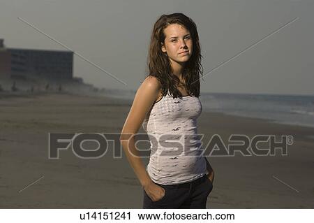 Stock Image - Portrait of teenage girl on beach. Fotosearch