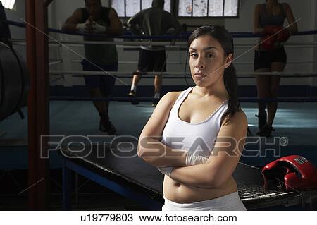 Stock Image - Portrait of woman by boxing ring. Fotosearch