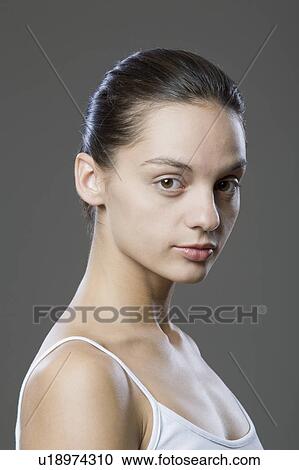 Stock Image - Portrait Of Young Woman, Studio Shot. Fotosearch