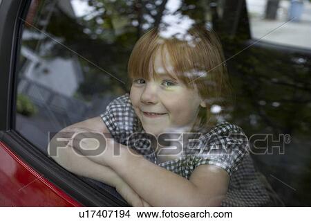 Pre-teen girl looking through car window View Large Photo Image Picture - Pre-teen girl looking through car window. Fotosearch
