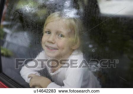 Pre-teen girl looking through car window View Large Photo Image Stock Image - Pre-teen girl looking through car window. Fotosearch
