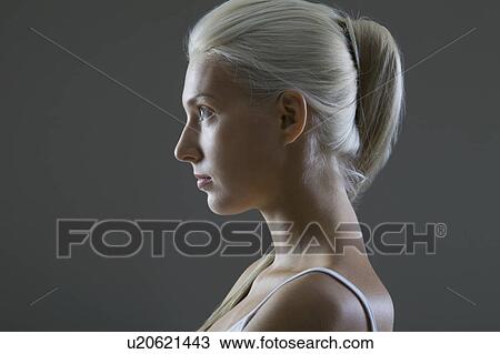 Stock Image - Profile of a young woman, studio shot. Fotosearch