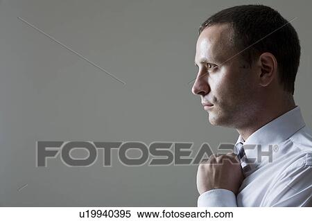 Stock Photography - Profile Of Businessman, Studio Shot. Fotosearch