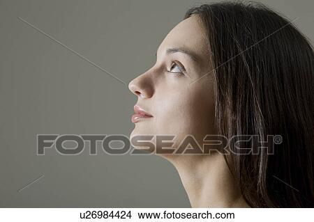 Picture - Profile Of Young Woman Looking Up, Studio Shot. Fotosearch