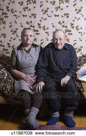 Stock Photo - Russia, senior couple sitting on bed. Fotosearch