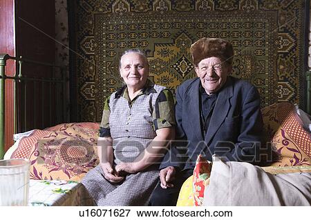 Russia, senior couple sitting on bed View Large Photo Image Stock Photo - Russia, senior couple sitting on bed. Fotosearch