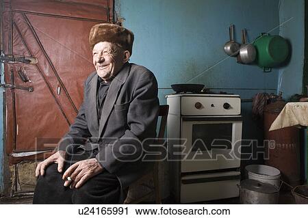 Russia, senior man sitting in kitchen View Large Photo Image Stock Image - Russia, senior man sitting in kitchen. Fotosearch