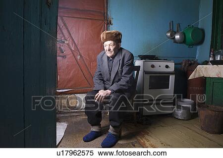 Russia, senior man sitting in kitchen View Large Photo Image Stock Photography - Russia, senior man sitting in kitchen. Fotosearch