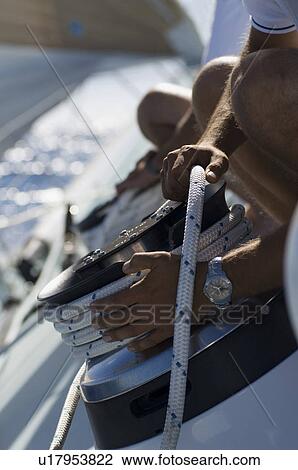Sailor tying rope onto windlass, close-up of hands View Large Photo Image Stock Image - Sailor tying rope onto windlass, close-up of hands. Fotosearch