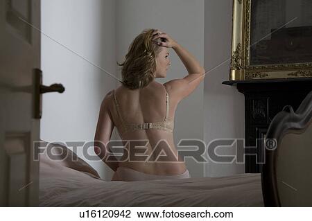 Semi-dress mid adult woman in old fashioned bedroom View Large Photo Image Stock Image - Semi-dress mid adult woman in old fashioned bedroom. Fotosearch