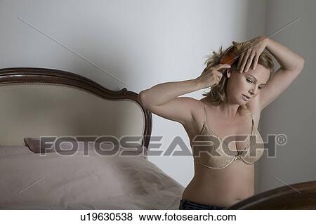 Semi-dress woman brushing her hair in old fashioned bedroom View Large Photo Image Stock Photo - Semi-dress woman brushing her hair in old fashioned bedroom. Fotosearch