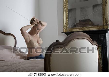 Semi-dress woman tying her hair in old fashioned bedroom View Large Photo Image Stock Image - Semi-dress woman tying her hair in old fashioned bedroom. Fotosearch