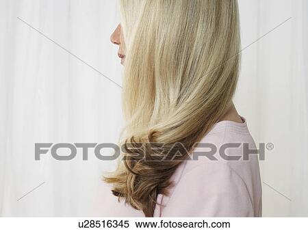 Stock Photography - Senior woman in studio, profile, face obscured by hair. Fotosearch