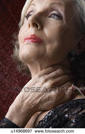 Stock Photo - Senior Woman with Hand on Neck. Fotosearch