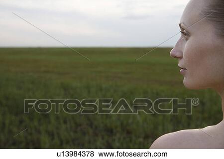 Serene young woman in meadow View Large Photo Image Stock Photo - Serene young woman in meadow. Fotosearch