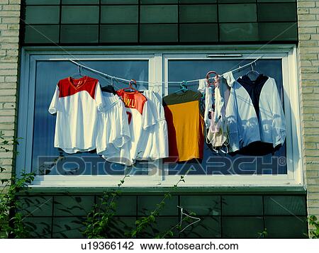 Shirts drying on clothesline outside window View Large Photo Image Stock Image - Shirts drying on clothesline outside window. Fotosearch