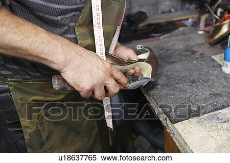 Stock Photography - Shoemaker Repairing High Heel Shoe. Fotosearch