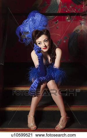 Stock Image - Showgirl using mobile phone. Fotosearch