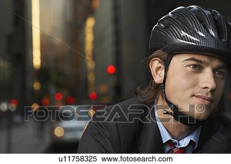 Smiling man wearing cycling helmet on street, close-up, portrait View Large Photo Image Stock Photography - Smiling man wearing cycling helmet on street, close-up, portrait. Fotosearch
