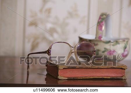 Spectacles on hardbacked book with china bowl View Large Photo Image Stock Photograph - Spectacles on hardbacked book with china bowl. Fotosearch