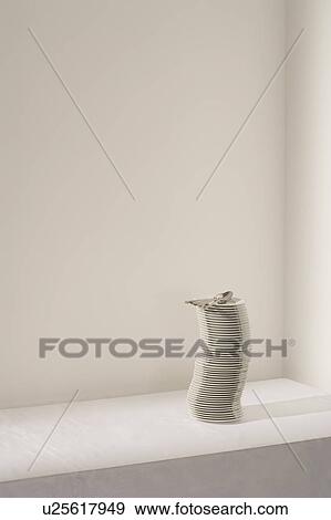 Stock Photo - Spoons on stack of plates on table. Fotosearch
