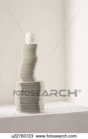 Stack of plates and cups on table View Large Photo Image Stock Image - Stack of plates and cups on table. Fotosearch