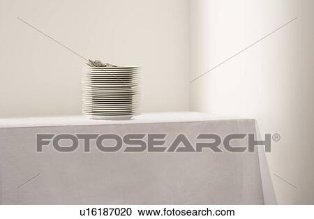 Stack of plates and cutlery on table View Large Photo Image Stock Image - Stack of plates and cutlery on table. Fotosearch