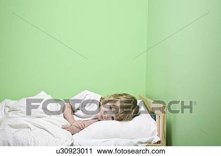 Studio shot of girl (5-6) lying in bed View Large Photo Image Stock Image - Studio shot of girl (5-6) lying in bed. Fotosearch