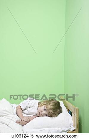 Studio shot of girl (5-6) lying in bed View Large Photo Image Stock Photography - Studio shot of girl (5-6) lying in bed. Fotosearch