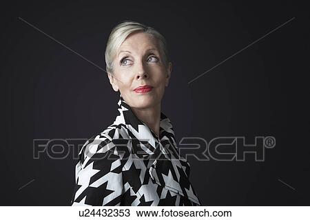 Stock Image - Stylish Senior Woman in black and white coat. Fotosearch