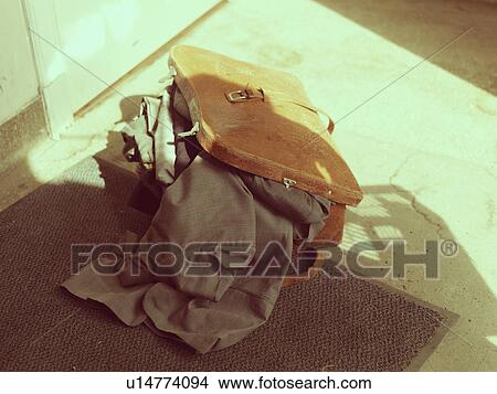 Suitcase with clothes sticking out View Large Photo Image Picture - Suitcase with clothes sticking out. Fotosearch