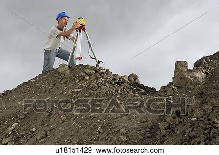 Surveyor using theodolite on site View Large Photo Image Stock Photo - Surveyor using theodolite on site. Fotosearch