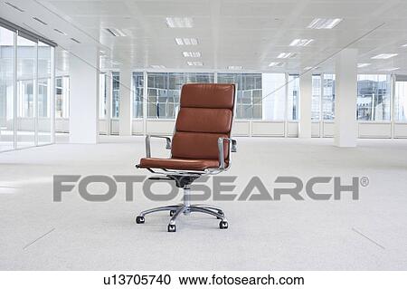 Swivel chair in empty office space View Large Photo Image Stock Image - Swivel chair in empty office space. Fotosearch