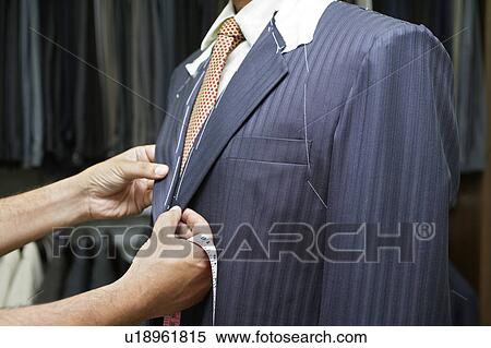 Stock Photography - Tailor Fitting Man in Suit. Fotosearch