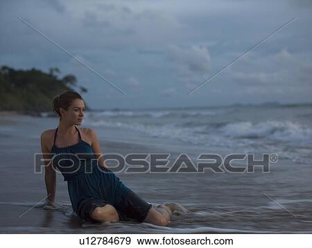 Thailand, young woman sitting on beach View Large Photo Image Stock Photo - Thailand, young woman sitting on beach. Fotosearch
