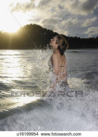 Thailand, young woman splashing in sea View Large Photo Image Picture - Thailand, young woman splashing in sea. Fotosearch