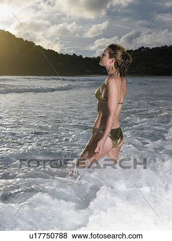Thailand, young woman walking in sea View Large Photo Image Stock Photo - Thailand, young woman walking in sea. Fotosearch