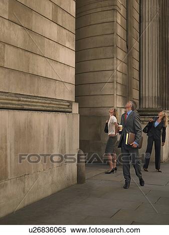 Three business people outside monumental building, looking up View Large Photo Image Stock Photography - Three business people outside monumental building, looking up. Fotosearch