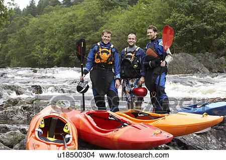 Three men with kayaks by river, portrait View Large Photo Image Picture - Three men with kayaks by river, portrait. Fotosearch