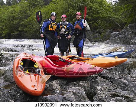 Three men with kayaks by river, portrait View Large Photo Image Stock Image - Three men with kayaks by river, portrait. Fotosearch