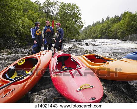 Three men with kayaks by river View Large Photo Image Stock Image - Three men with kayaks by river. Fotosearch