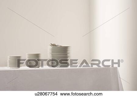 Three stacks of plates and cutlery on table View Large Photo Image Picture - Three stacks of plates and cutlery on table. Fotosearch