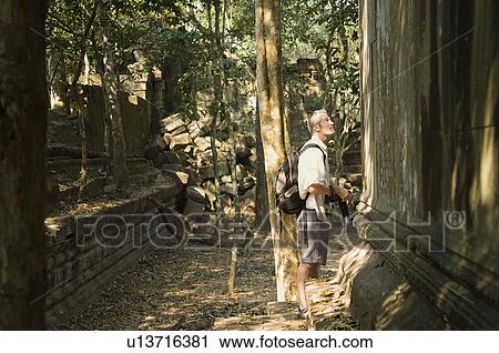 Stock Image - Tourist Among Ruins. Fotosearch