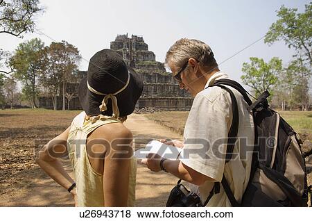 Stock Photo - Tourists Looking at at Temple Ruins. Fotosearch
