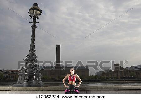 Triathlon athlete wearing gold medal, standing against river embankment, London, England View Large Photo Image Picture - Triathlon athlete wearing gold medal, standing against river embankment, London, England. Fotosearch
