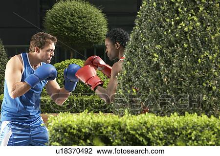 Stock Image - Two boxers fighting in park. Fotosearch